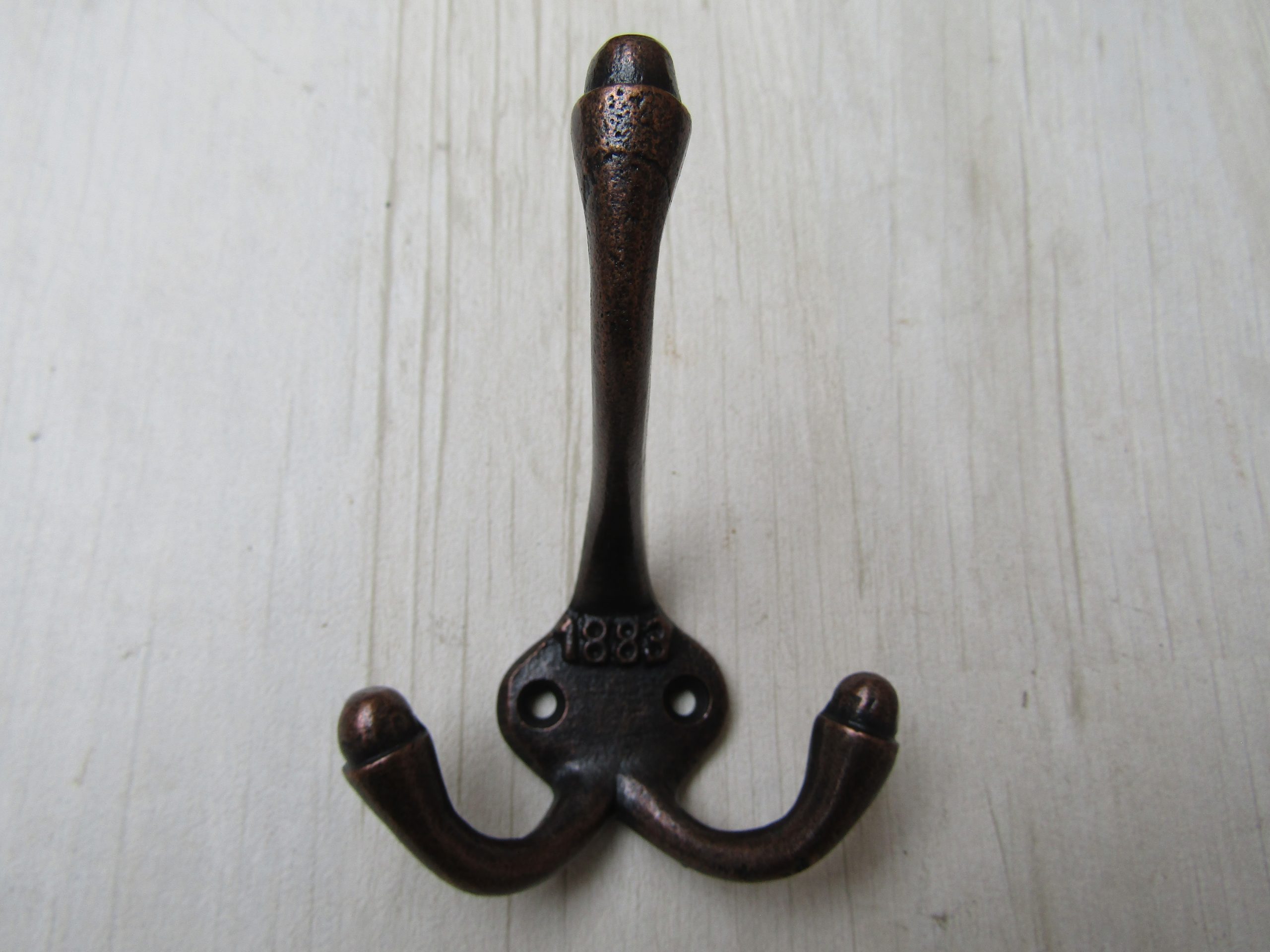 Small 1883 Embossed Coat Hook Antique Copper